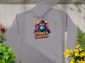 The Garment Graphics gray hoodie showcases gorillas with hats and sunglasses, reading Gorilla Gangster. Surrounded by plants and flowers on a stone surface, its a standout piece in streetwear gangster hoodies.