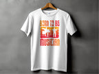 The Garment Graphics Born To Be Musician T-shirt hangs on a wooden hanger, perfect for music lovers. The white tee features the phrase in a red-orange gradient with silhouettes of a drummer against gray, ideal for passionate drummers or guitarists.