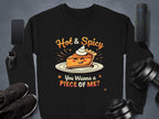 A Garment Graphics black sweatshirt features a playful pie character with sunglasses and whipped cream, reading Hot & Spicy. You Wanna a Piece Of Me? Its unisex and surrounded by a smartphone, smartwatch, sneakers, speaker, and dumbbells.