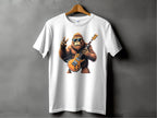 A white T-shirt by Garment Graphics hangs on display, featuring a groovy gorilla in sunglasses playing an electric guitar and giving the peace sign. Ideal for music lovers, its set against a plain gray wall.