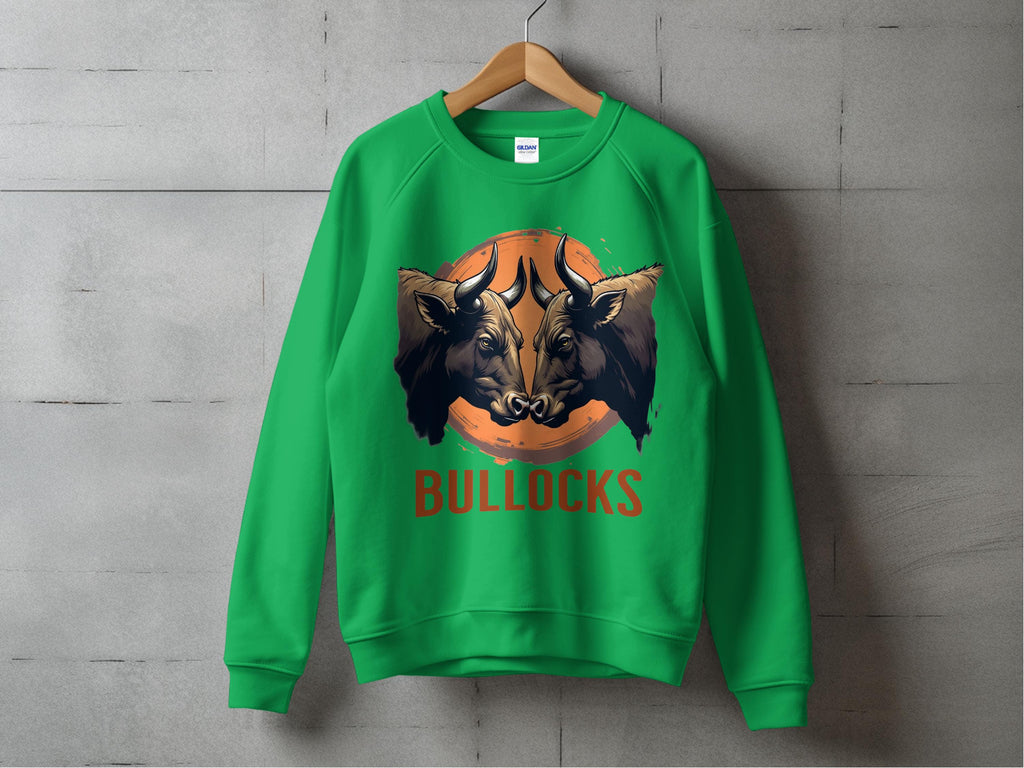 A green Garment Graphics sweatshirt with a bold bullock design hangs on a wooden hanger against a concrete wall. Unisex sizing lets everyone enjoy the bulls head illustration, with BULLOCKS in striking red letters below.