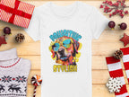 A white womens t-shirt by Garment Graphics, featuring a colorful graphic of a dog in sunglasses and Pawsitive Stylish, is displayed on wood. It’s surrounded by wrapped gifts, candy cane, pine cones, a reindeer sweater, and a red star decoration.