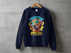 A navy blue sweatshirt by Garment Graphics hangs against a gray wall, showcasing a canine in sunglasses with the text Pawsitive Stylish and Celebrate Every Canine Walker, ideal for dog lovers who enjoy Dog Graphic Sweatshirts.