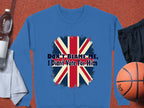A blue Garment Graphics sweatshirt with a bold Union Jack and DONT BLAME ME, I Didnt Vote For Him design rests next to a water bottle, towel, basketball, and shorts.