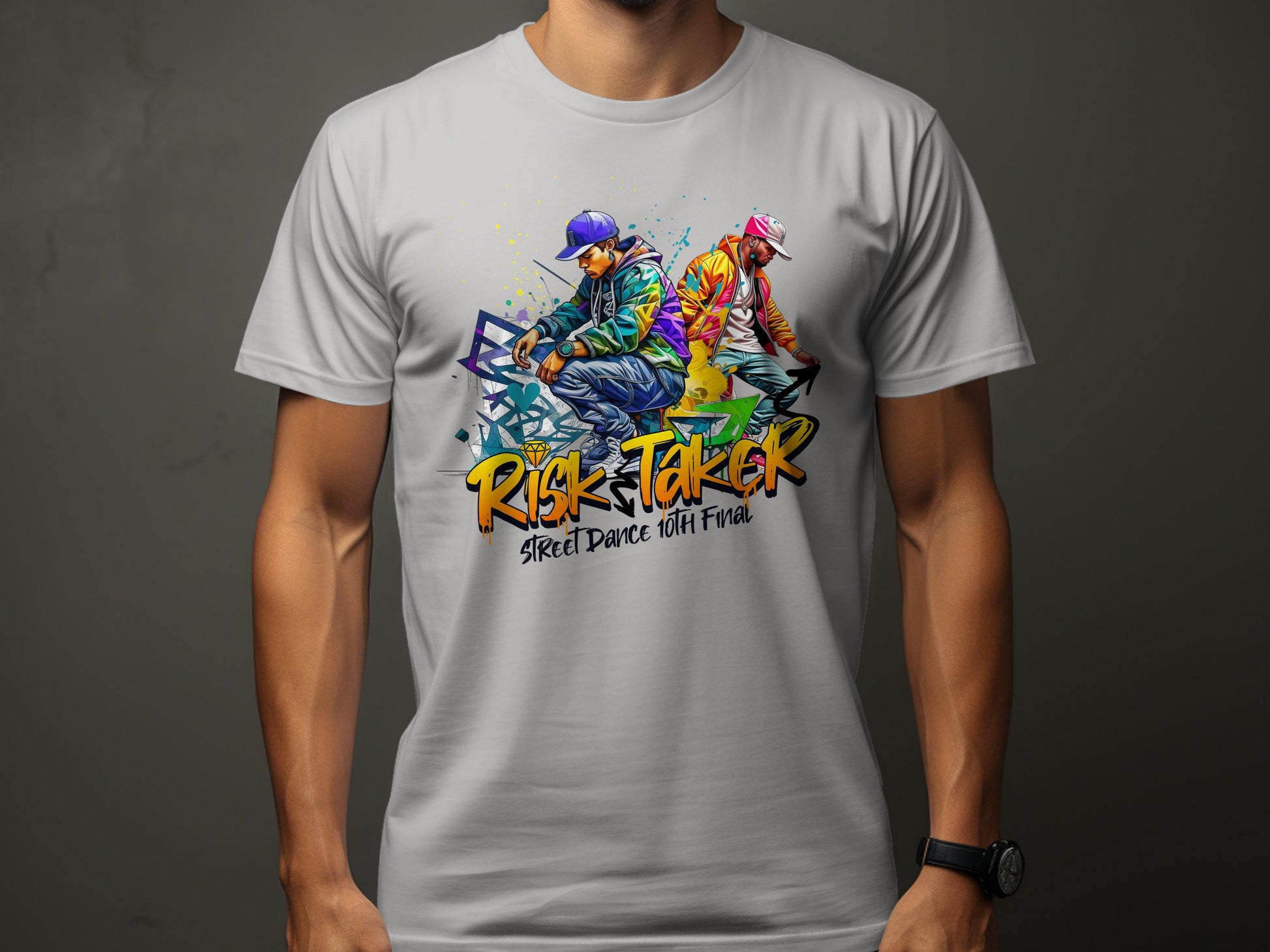 A man wears a gray Risk Taker, Street Dance 10th Final t-shirt by Garment Graphics, featuring an artistic design of two dancers in vibrant attire and caps, capturing the essence of street dance culture.