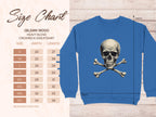 A blue crewneck sweatshirt from Garment Graphics showcases a bold skull and crossbones print. On the left, a size chart for the Gildan 18000 Heavy Blend displays dimensions in inches for sizes S to 5XL against a light patterned background.
