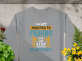 Garment Graphics presents a gray unisex T-shirt featuring Im Not Addicted to Fishing, We Are Just in a Very Committed Relationship in assorted fonts and colors. The shirt is showcased on a stone with surrounding green plants and yellow flowers.