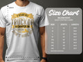 A person is wearing a Garment Graphics white T-shirt featuring a funny camping-themed design about hiring someone for their truck and camper. Beside them, a Gildan 5000 heavy cotton size chart shows sizes S to 5XL with corresponding width and length in inches.
