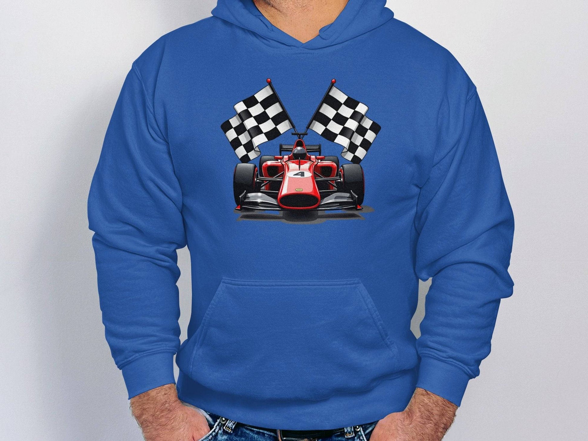 Dressed in a Garment Graphics hoodie featuring crossed checkered flags behind a red race car, the person stands confidently against a plain background.