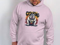 A person wears a Garment Graphics light pink classic fit hoodie featuring a graphic bulldog with a gold chain and sunglasses, topped by the words City King, making it perfect for any casual wardrobe.