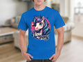 A unicorn fan wears a bright blue Garment Graphics T-shirt showcasing a big-eyed cartoon unicorn with a vibrant mane, alongside the text I love my pony, set against a blurred indoor background.