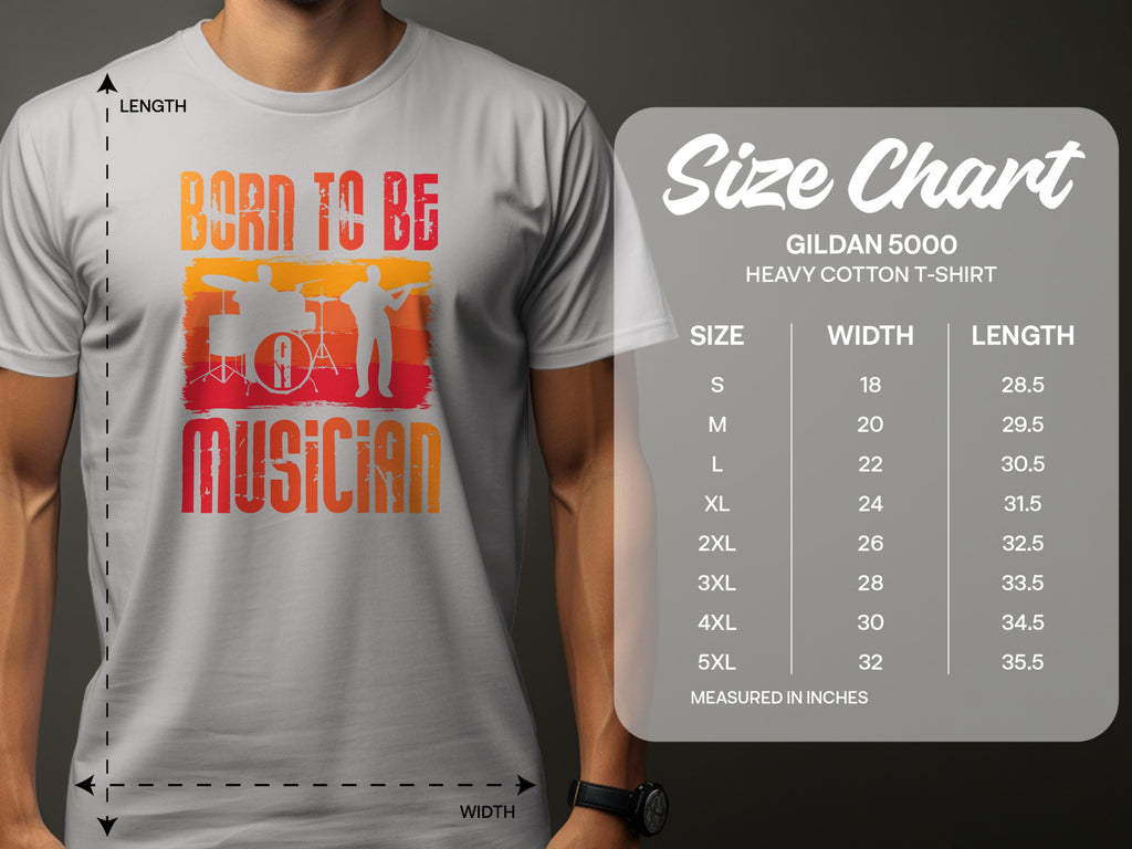 A person wears a white Garment Graphics Born To Be Musician T-shirt, ideal for music lovers, featuring drummer and guitarist silhouettes. Beside it is a size chart for Gildan 5000 heavy cotton tees, detailing sizes S to 5XL with corresponding width and length in inches.