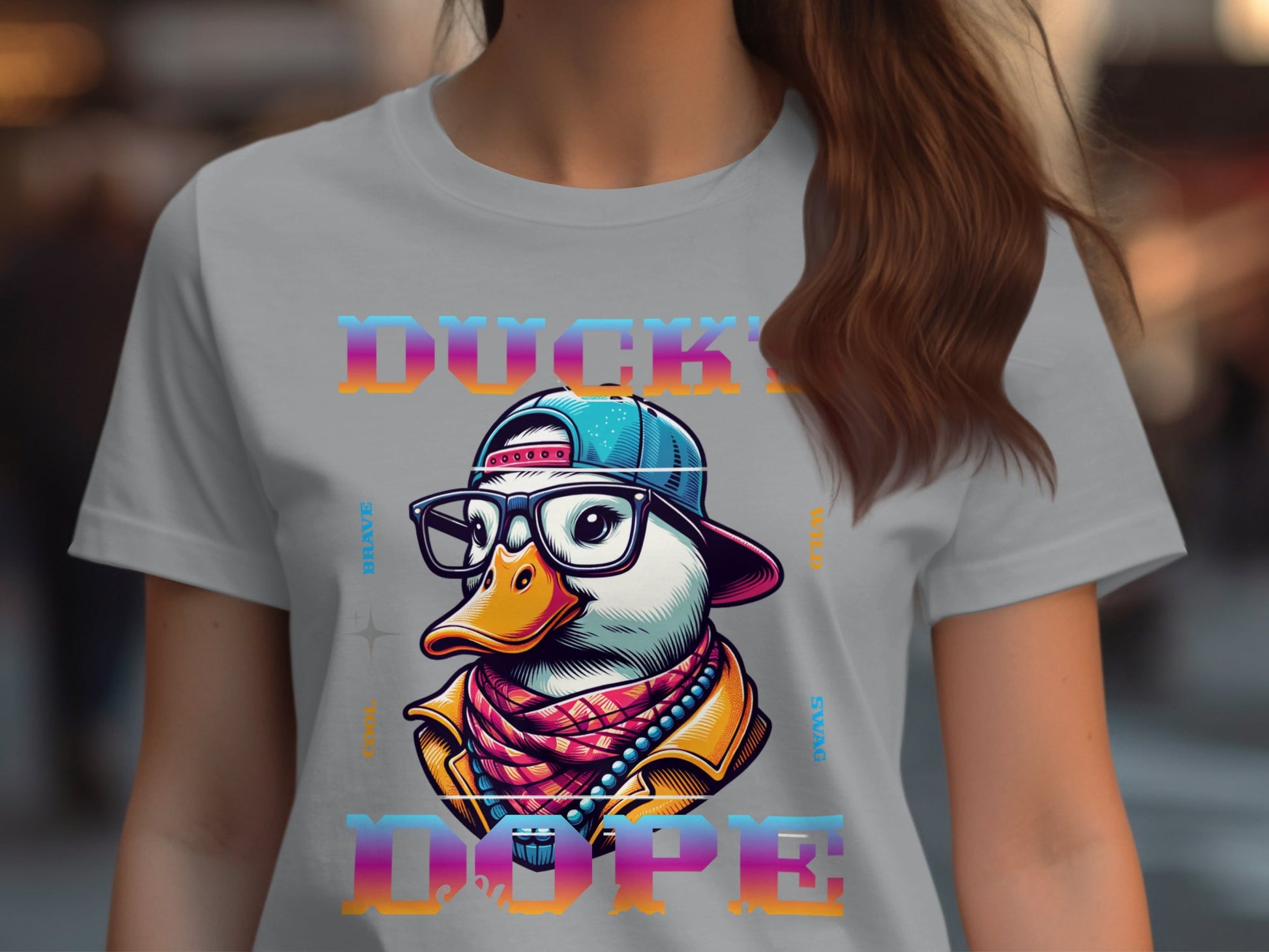 This stylish T-shirt from Garment Graphics showcases a vibrant graphic of a duck wearing glasses, a backward cap, and a scarf, surrounded by the phrase DUCKY DOPE in stylized text, capturing that Cool Brave Wild Swag Duck vibe perfectly.