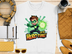The unisex white T-shirt by Garment Graphics showcases a brown-haired cartoon character with green gloves emitting a green energy blast, and the text Its Hero Time! Complete your look with accessories like a scarf, notebook, pen, coffee cup, sunglasses, purse, and jacket. Perfect for cartoon-themed ensembles!.