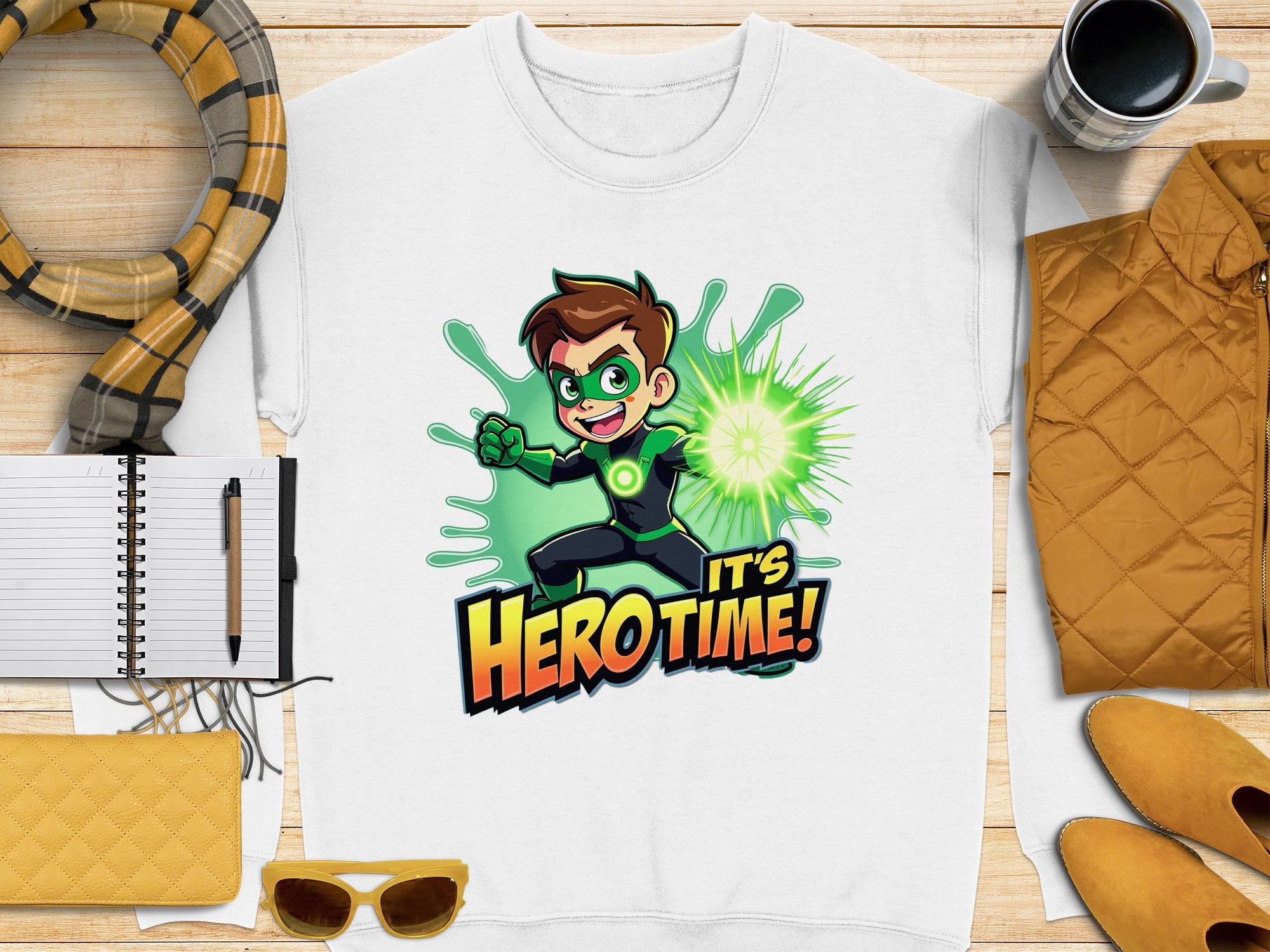 The unisex white T-shirt by Garment Graphics showcases a brown-haired cartoon character with green gloves emitting a green energy blast, and the text Its Hero Time! Complete your look with accessories like a scarf, notebook, pen, coffee cup, sunglasses, purse, and jacket. Perfect for cartoon-themed ensembles!.