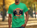 A person wears a Garment Graphics classic fit green T-shirt with two angry bulls facing each other above BULLOCKS. Theyre in a park with vibrant autumn trees, ideal for family outings and flaunting your Bullocks Pintable T-Shirts style.