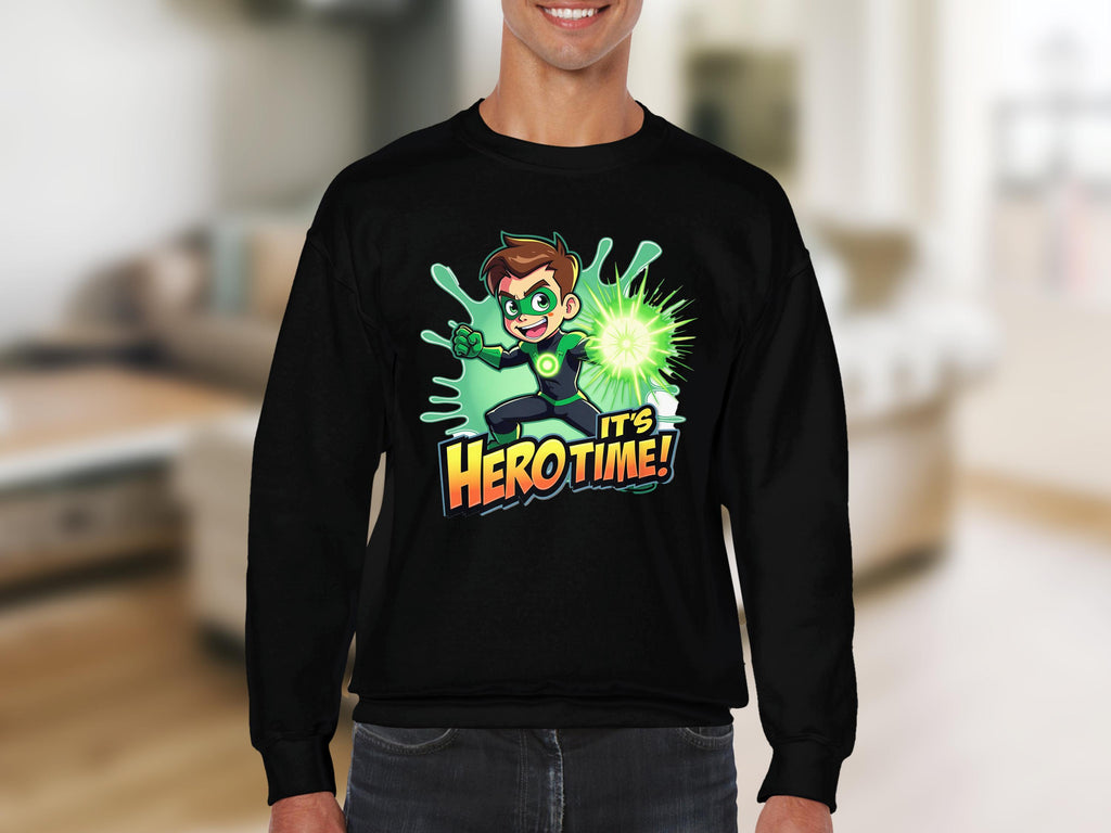 Someone is wearing a colorful Garment Graphics sweatshirt with an Its Herotime design, showcasing a cartoon character emitting green energy. Ideal for adventure-loving youth, it proudly displays the text Hero Time! against a cozy living room backdrop.