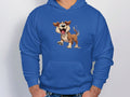 The person wears a delightful blue hoodie from Garment Graphics, ideal for dog lovers. It features a cartoon dog standing on its hind legs with floppy ears and a joyful expression. Their hands are tucked in the hoodie’s front pocket.