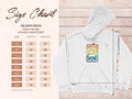 The size chart for the Garment Graphics Gildan 18500 heavy blend sweatshirt offers sizes S to 5XL, detailing width and length in inches. This retro hoodie has a white base with a Woodstock 1969 graphic in rainbow colors and peace symbols, ideal for graphic print hoodie enthusiasts.