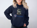 Someone is wearing a Garment Graphics Scania Truck Hoodie featuring a bold graphic of a Scania truck with the iconic logo. The hoodie has a light-colored background, ideal for truck enthusiasts who prefer subtle yet striking apparel.