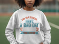 A person models the Garment Graphics unisex fishing sweatshirt with the slogan Id rather have a bad day fishing than a good day at work in decorative text and fish graphics, perfectly complementing the overcast backdrop.