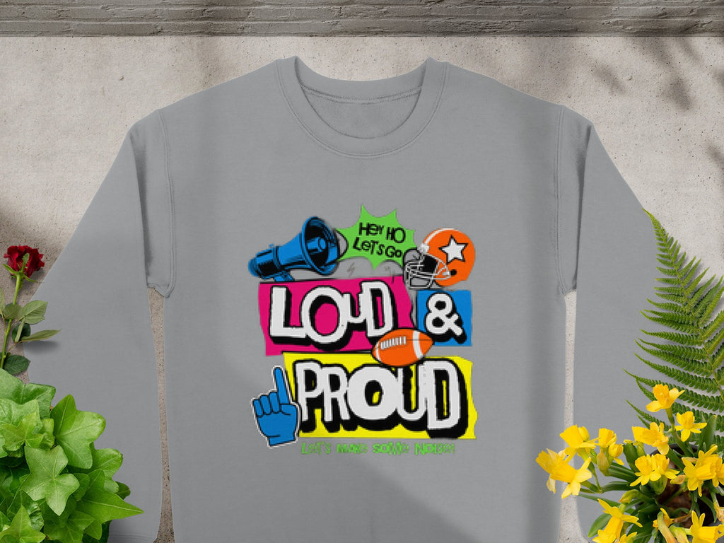 Introducing Garment Graphics Loud and Proud Sweatshirt in unisex sizing—a gray design featuring vibrant text, icons like a megaphone, football, foam hand, and helmet. With phrases like Hey Ho Lets Go, it’s perfect for making a statement while enjoying the ambiance of potted plants.