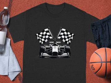 A Garment Graphics black graphic T-shirt with a Formula One car and checkered flags is on a sports court, alongside a basketball, dark blue shorts, a white towel, and a clear water bottle.