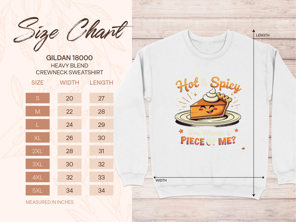 Garment Graphics white crewneck sweatshirt showcases a playful pie character with whipped cream, Hot & Spicy text above, and You Wanna Piece of Me? below. Available in unisex sizes S to 5XL with measurements in inches.