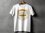 A white Garment Graphics t-shirt features the witty text: If hes got golf clubs in his truck or a camper in his driveway, I dont hire him, in gold and gray fonts, adding a humorous camping touch.