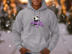 A person wears a cozy light gray hoodie from Garment Graphics, featuring a soccer ball with SOCCER MOM in white and pink lettering. This classic fit is perfect for any Soccer Mum, set against a bokeh lights background.