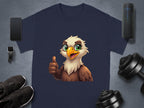 The Garment Graphics navy blue Eagle T-shirt has a cartoon eagle giving a thumbs up. Ideal for your casual wardrobe, its showcased with a smartphone, wireless speaker, smartwatch, black sneakers, and adjustable dumbbells on a gray background.