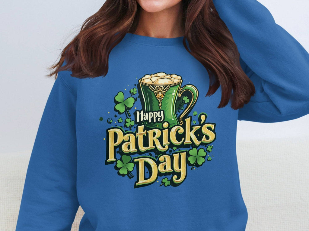 A person wears a vibrant Garment Graphics sweatshirt with a St. Patrick’s Day design featuring a green frothy mug, shamrocks, and the words Happy Patricks Day in stylized text.