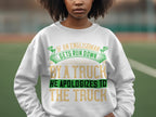 Someone wearing a bold, unisex sweatshirt by Garment Graphics with the humorous text, If an Englishman gets run down by a truck, he apologizes to the truck. The design makes a statement on the sports field.