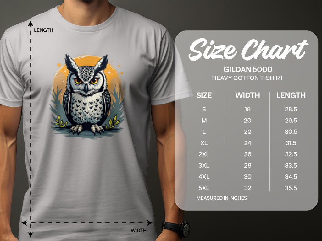 A person is wearing a Garment Graphics white T-shirt featuring an owl graphic with a yellow circle, adding artistic flair. Beside it, a size chart for the Gildan 5000 Heavy Cotton T-Shirt shows sizes S-5XL with corresponding width and length measurements in inches.