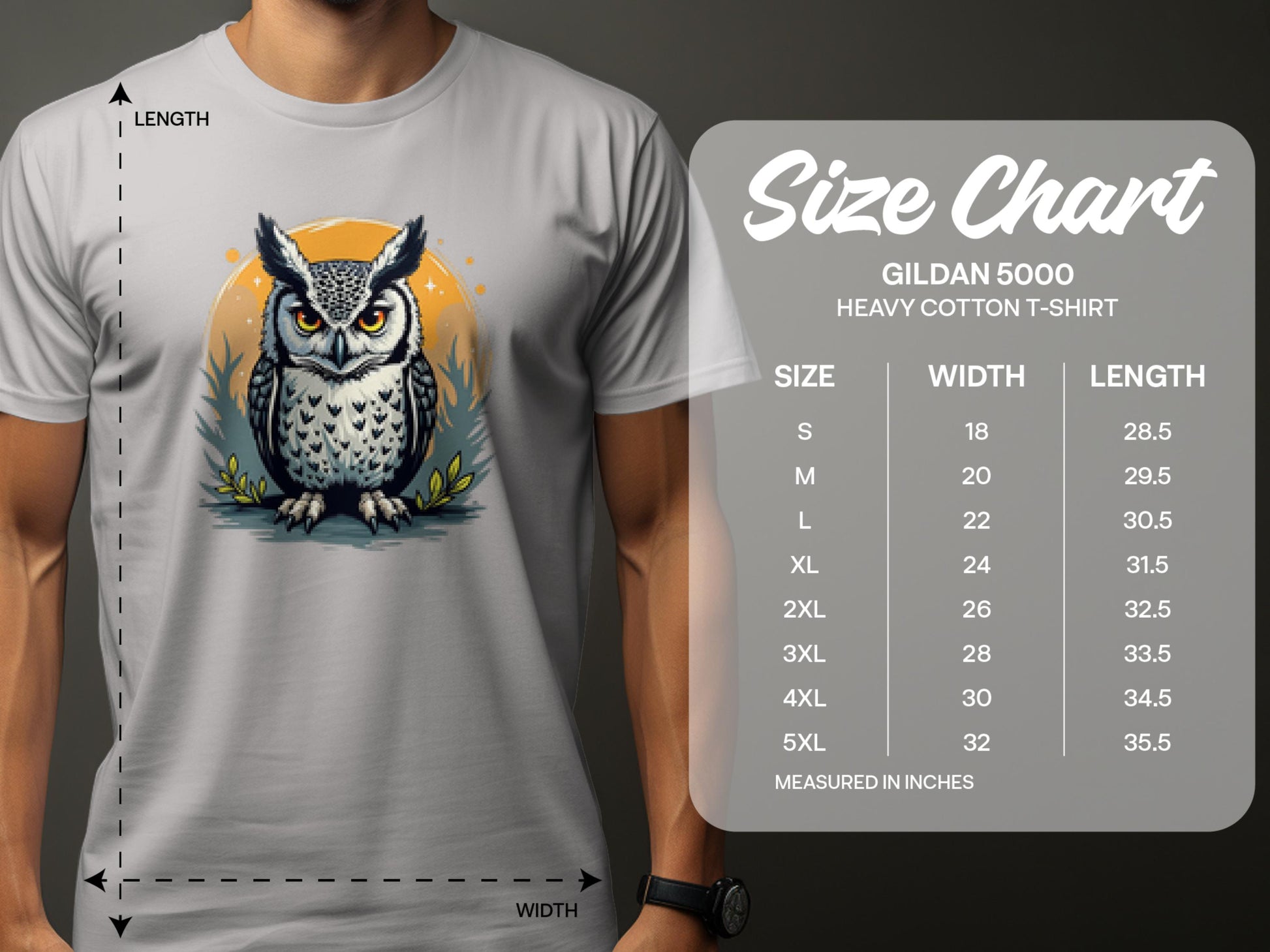 A person is wearing a Garment Graphics white T-shirt featuring an owl graphic with a yellow circle, adding artistic flair. Beside it, a size chart for the Gildan 5000 Heavy Cotton T-Shirt shows sizes S-5XL with corresponding width and length measurements in inches.