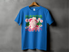 Garment Graphics presents a blue T-shirt on a hanger with a bold design of a woman in a hat, finger to lips, surrounded by flowers. It features HANDS OFF! text and Wild Side in smaller print with hearts and stars. Available in family sizes for all.