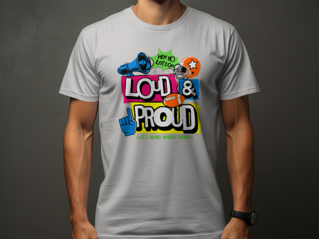 A person wearing a Garment Graphics white t-shirt with colorful graffiti-style text, Loud & Proud, featuring a megaphone, star, and foam finger. Ideal for football sports enthusiasts to showcase passion, it also reads Hey Ho Lets Go! Lets make some noise!.