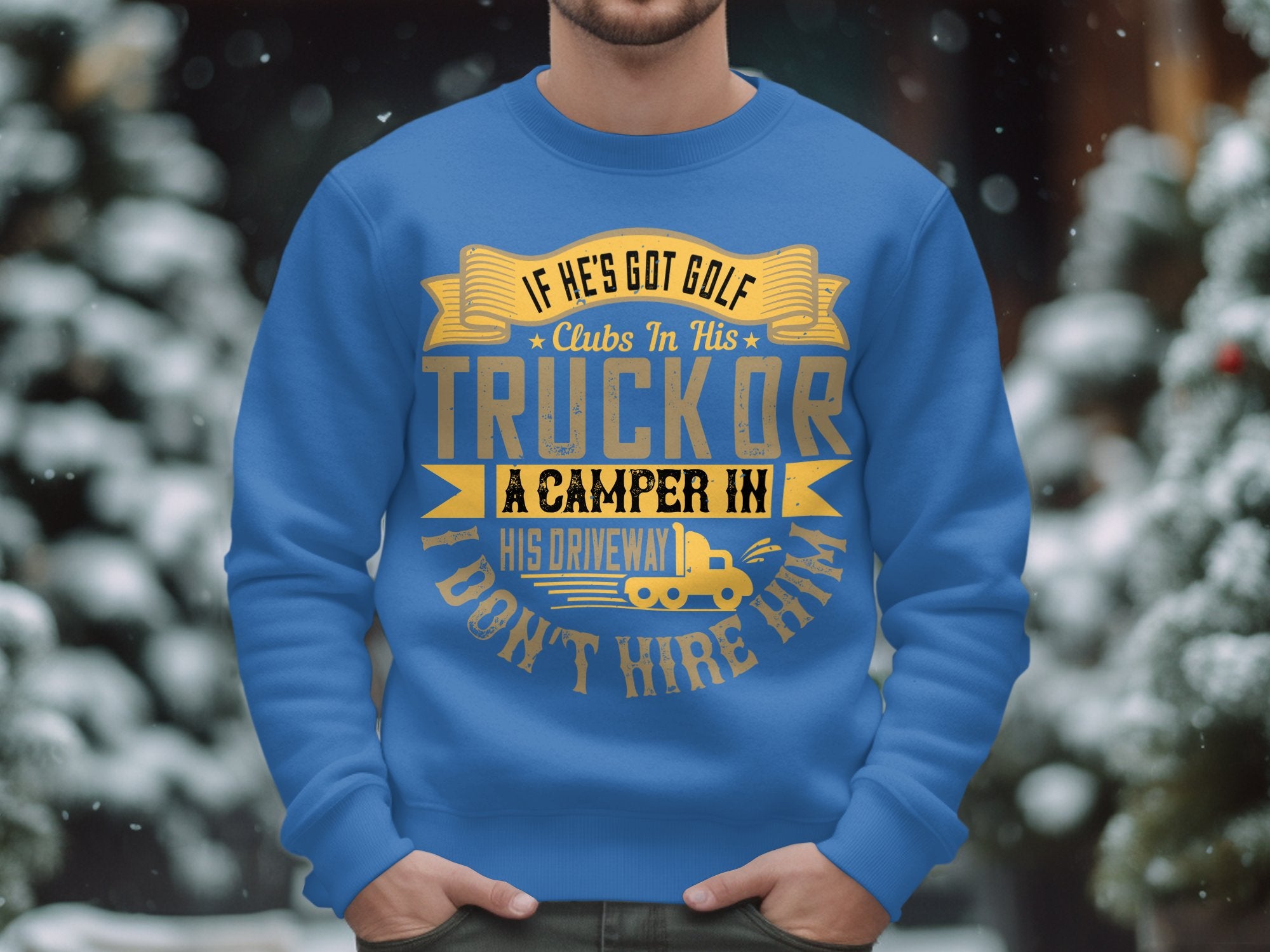 Amid blurred snowy trees, a person in a Garment Graphics blue sweatshirt featuring the text, If hes got golf clubs in his truck or a camper in his driveway, I dont hire him, embraces the spirit of camping and a passion for golf.