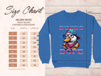 A size chart for Garment Graphics Gildan 18000 crewneck sweatshirts (unisex sizing) sits beside a blue sweatshirt with a cartoon duck in a hat and checkered scarf, labeled Ducks Dope. The cool swag sweatshirts, made from medium-heavy fabric, are available in sizes S to 5XL.
