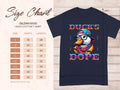 On the left, a size chart from S to 5XL for Garment Graphics Ducks Dope T-Shirt shows dimensions in inches. On the right, an eye-catching design depicts a duck with glasses, hat, and scarf alongside Ducks Dope text.