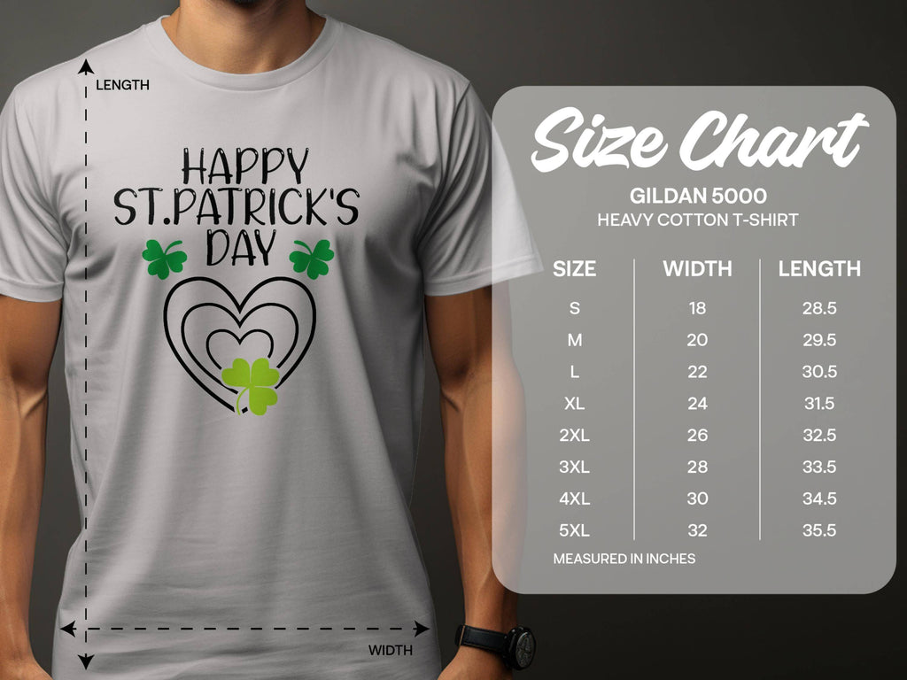 A person is wearing a graphic gray T-shirt by Garment Graphics, featuring Happy St. Patricks Day and clover designs. A size chart on the right shows measurements for Gildan 5000 heavy cotton T-shirts, detailing width and length in inches across various sizes.
