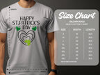 A person is wearing a graphic gray T-shirt by Garment Graphics, featuring Happy St. Patricks Day and clover designs. A size chart on the right shows measurements for Gildan 5000 heavy cotton T-shirts, detailing width and length in inches across various sizes.