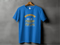 A blue t-shirt with Garment Graphics yellow and white fishing boat and fish design hangs against a gray wall. It features the text Father and Son Fishing Partners for Life, celebrating family bonding with personalized fishing tees.