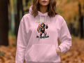 A person dons a Garment Graphics light pink hoodie with a classic fit, showcasing Bigfoot holding a peace sign. The text says, ADMIT IT. Life would be boring without me, against blurry autumn foliage.