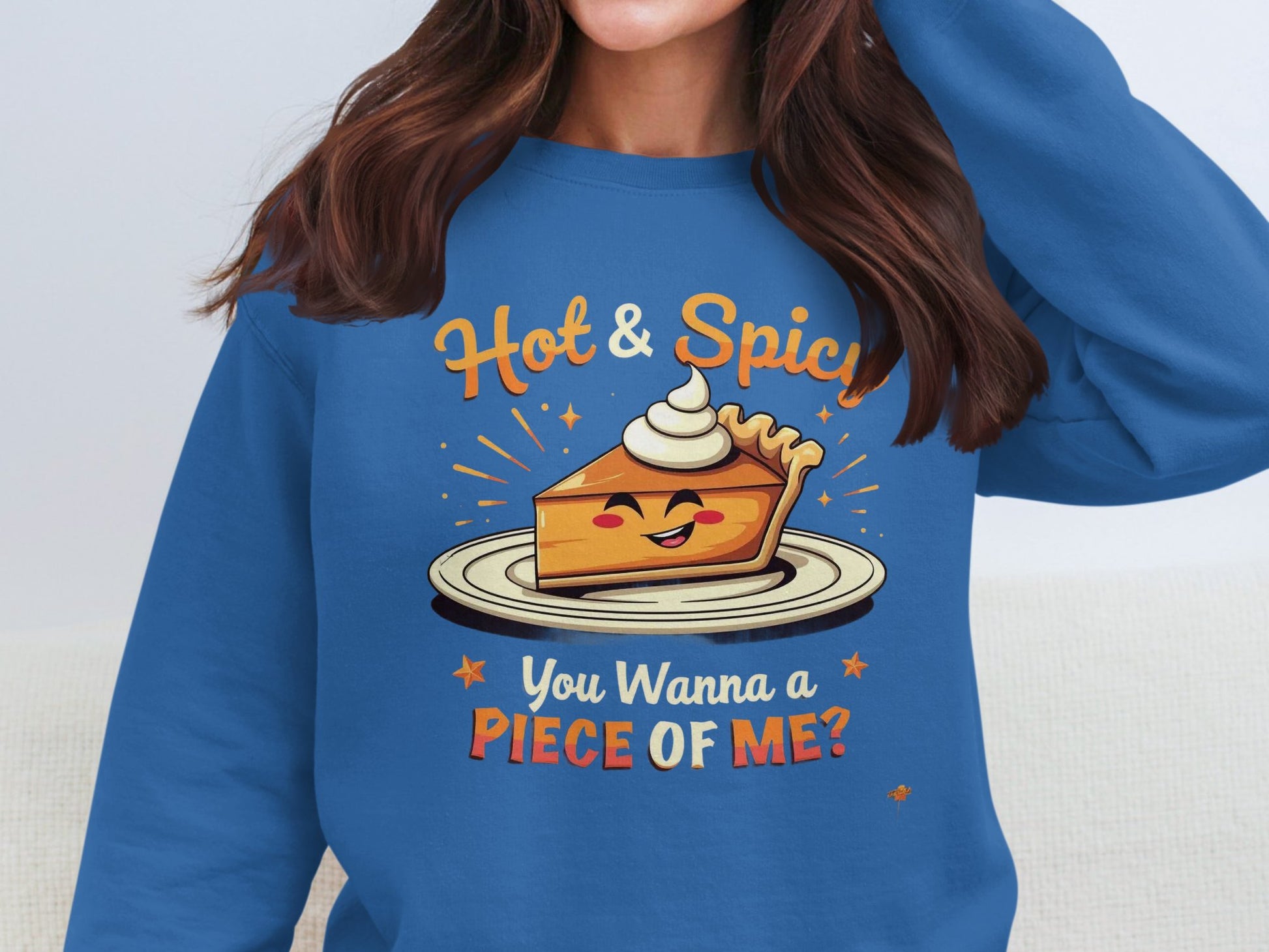 A person in a Garment Graphics pie graphic sweatshirt features a smiling pie slice with whipped cream, and the text Hot & Spicy, You Wanna a Piece of Me? The unisex sweatshirt adds flair while their face stays unseen.