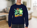 Wearing Garment Graphics unisex navy cartoon-themed sweatshirt, a character with spiky brown hair holds a glowing green energy source above the text Its Hero Time! against a blurred indoor background.