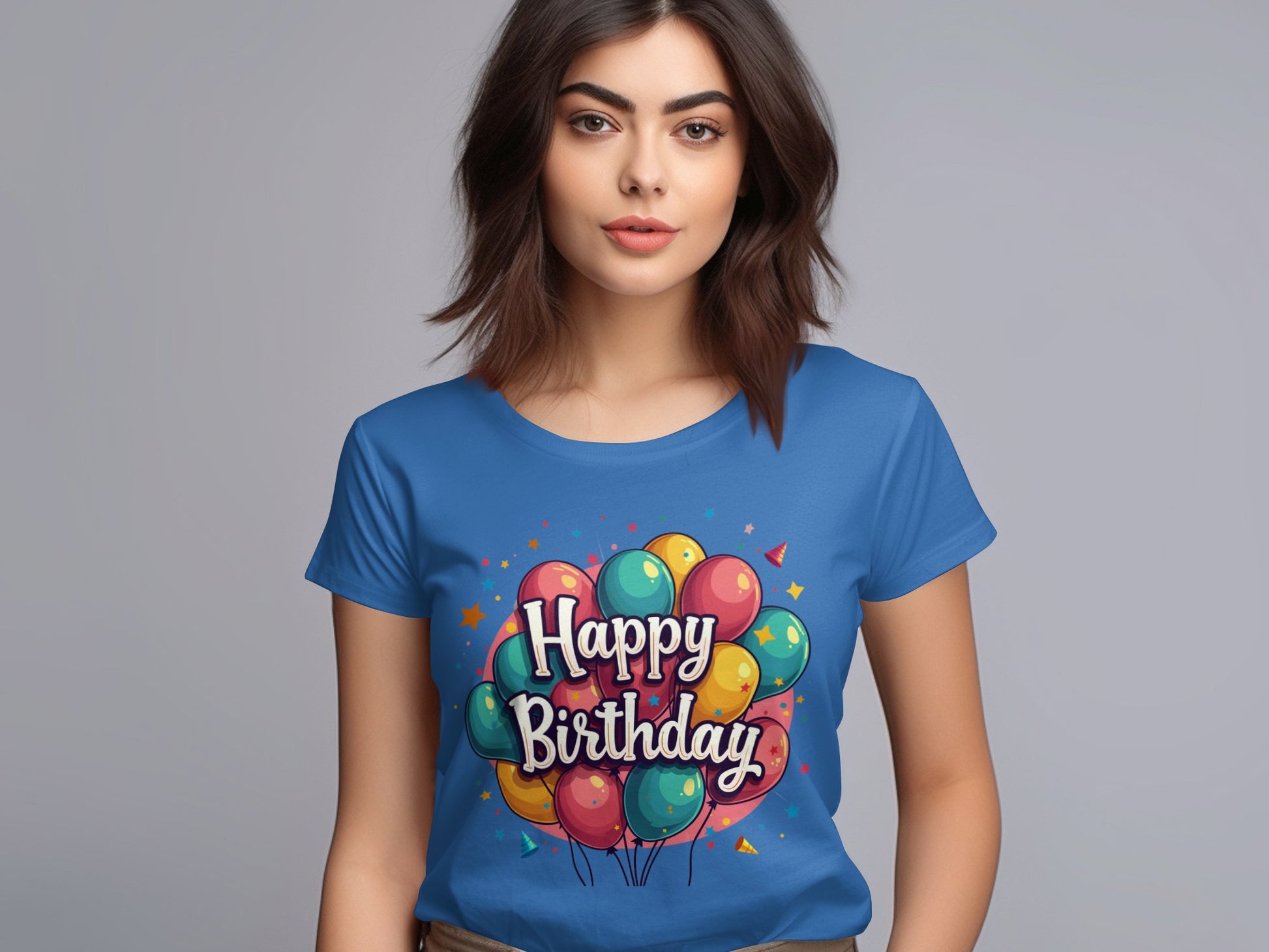 A woman stands against a gray background wearing a vibrant blue 100% cotton t-shirt by Garment Graphics, featuring a colorful birthday balloon design and the words Happy Birthday, ideal for any birthday celebration.