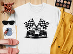 Flat lay showcasing Garment Graphics white shirt with checkered flag print, styled with pink loafers, a mustard jacket, sunglasses, makeup brushes, eyeshadow palette, nail polish, and a small pouch on a wooden surface.