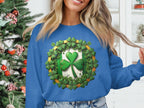 Sporting a Garment Graphics blue sweatshirt adorned with a large shamrock and smaller ones, an individual channels Irish spirit in front of a Christmas tree, holding a section of their long blonde hair.