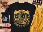 A black Garment Graphics sweatshirt humorously displays: If hes got golf clubs in his truck or a camper in his driveway, I dont hire him. Styled with sunglasses, makeup, a mustard blazer, pink shoes, and a blue pouch on wood for a perfect casual look.